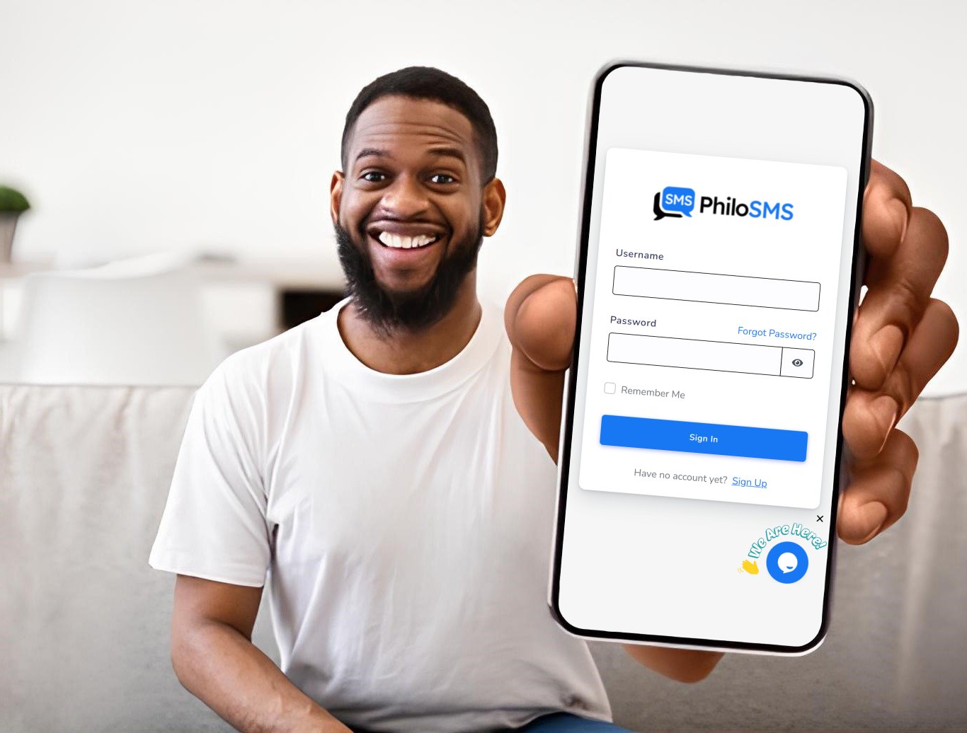 Smiling man showing PhiloSMS on his phone